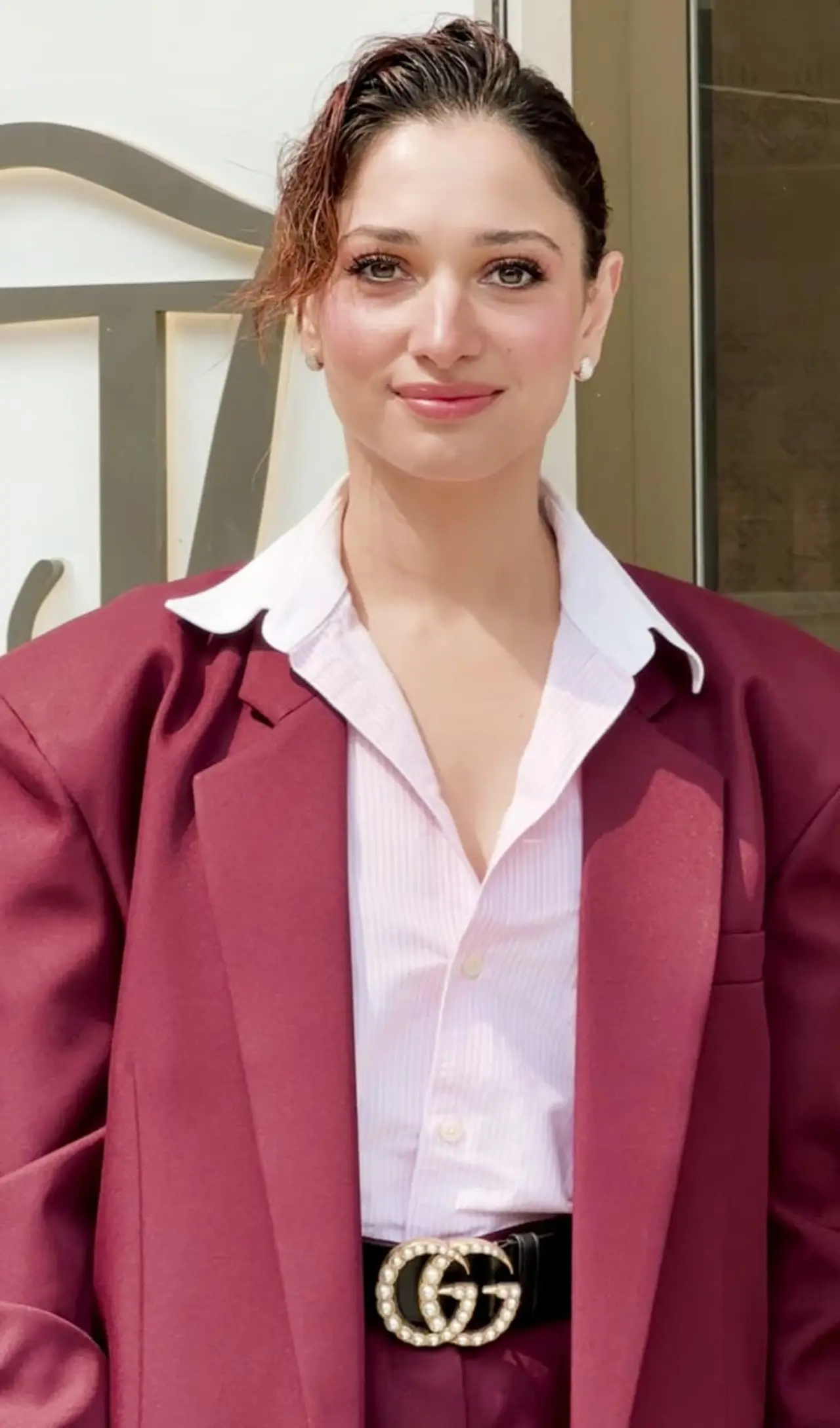 Tamannaah flaunted a minimal, flushed-out makeup look. She tied her hair up in a bun while keeping it messy. 